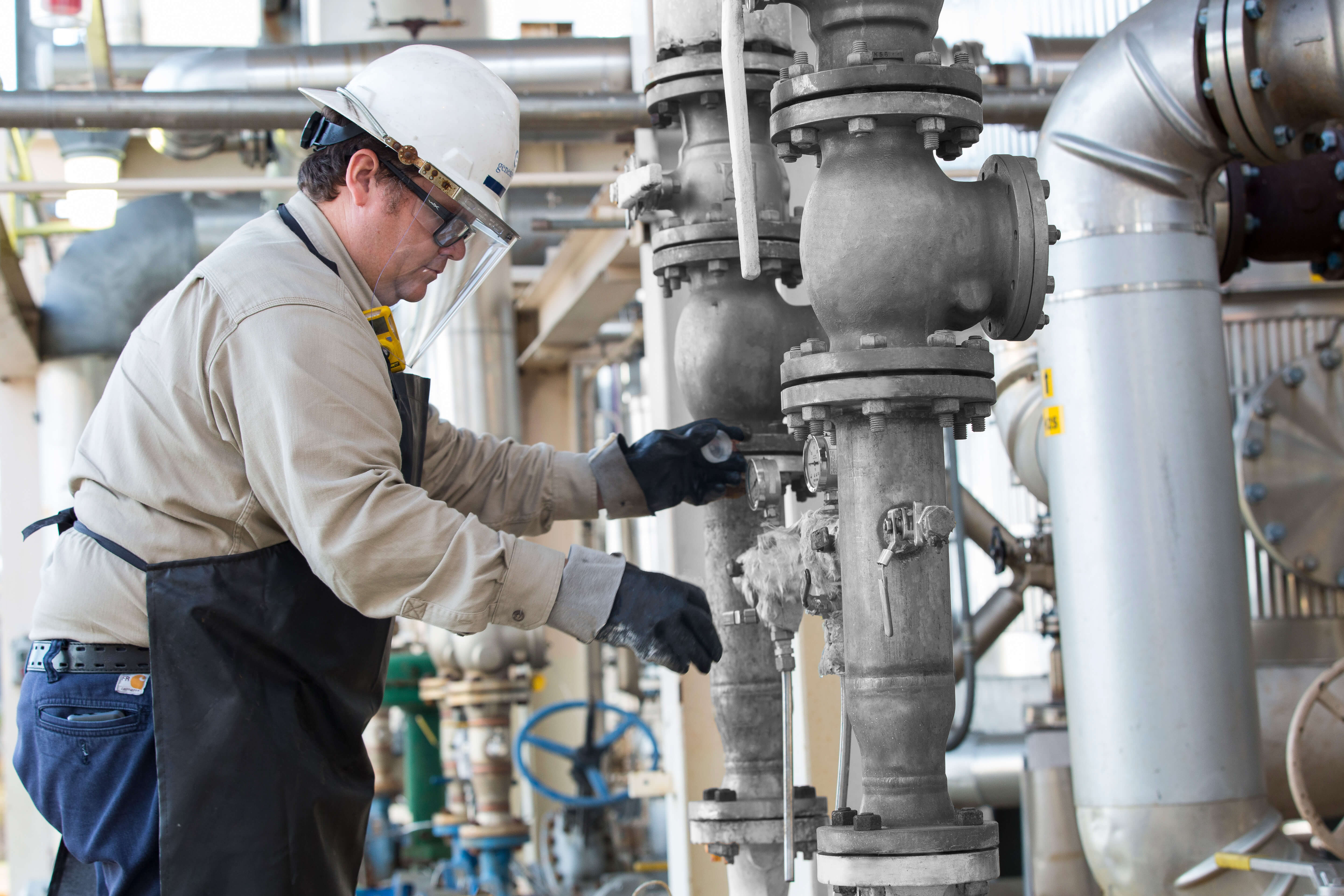 Genesis Energy employee working on equipment