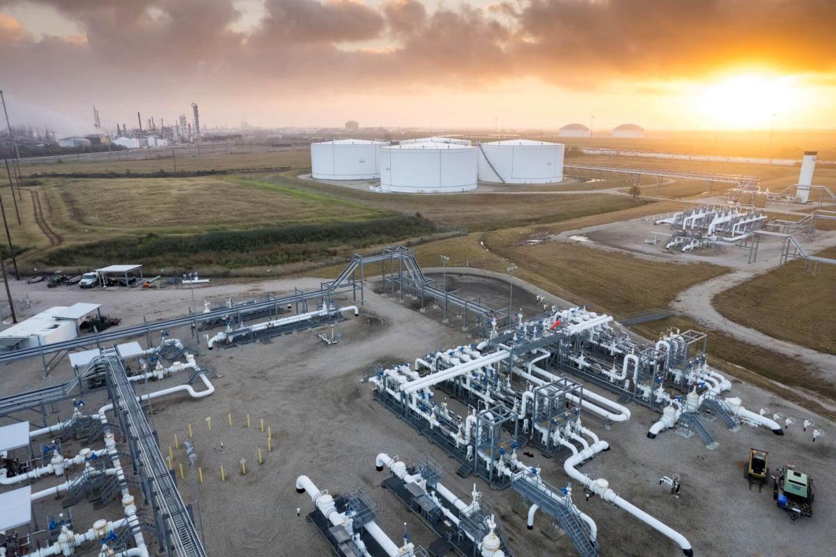 Onshore tanks and equipment with sunset in background in Texas City, TX